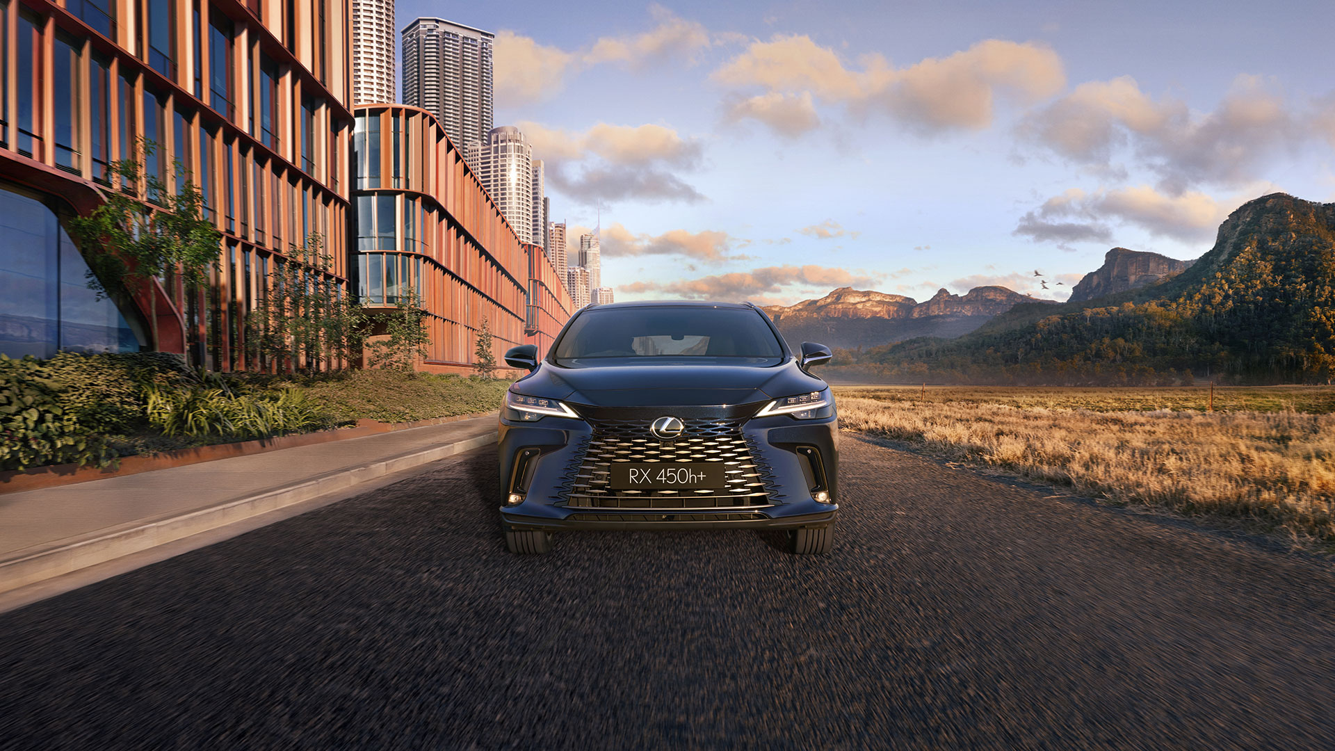 Lexus RX 450h+ driving with a scenic background